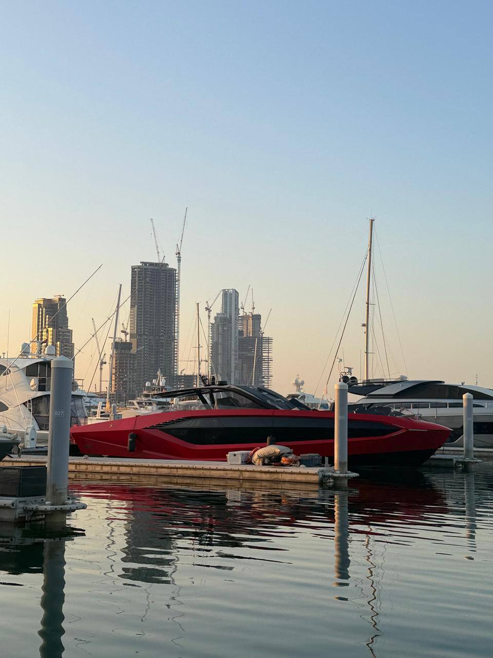 The red yacht in profile against the Dubai marina skyline